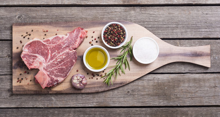 Raw beef steak T bone with ingredient