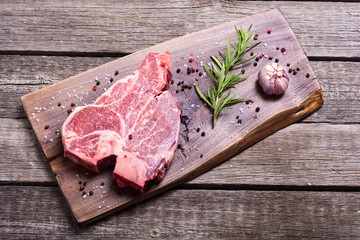 Raw beef steak T bone with ingredient