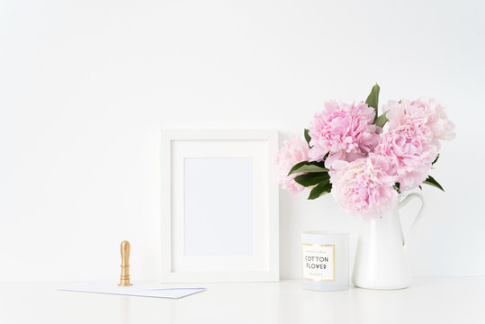Stylish white a5 blank frame mockup. Still life composition, floral bouquet of pink peonies in jug, gold stamp and con. Background, mock up for quote, promotion, headline, design and social media