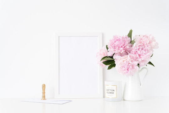White a4 blank frame mockup. Still life composition, floral bouquet of pink peonies in jug, gold stamp and con. Background, mock up for quote, promotion, headline, design, lifestyle bloggers