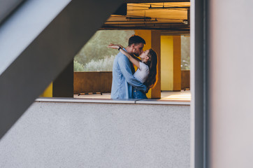 Obraz na płótnie Canvas Man kissing his girlfriend in the parking