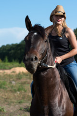 Young beautiful girl with a horse on nature