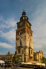 Fototapeta na wymiar Town Hall Tower in Krakow, located in the Main Market Square in the Old Town district of the city. Sunny day with a lot of tourist enjoying the day.