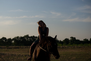 Young beautiful girl with a horse on nature