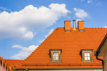 shingles red roof background symmetry concept for wallpaper in summer bright colorful day time with empty space for copy or text