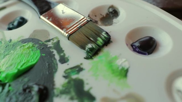 paint brush on a paint palette