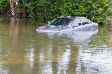 Cars submerged in Houston, Texas, US during hurricane Harvey. Water could enter the engine, transmission parts or other places. Disaster Motor Vehicle Insurance Claim Themed. Severe weather concept
