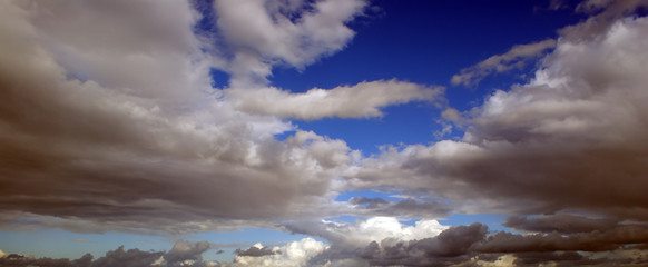 Blue sky with dark stormy clouds