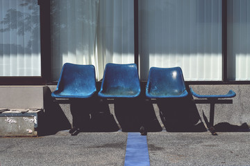Old blue plastic chairs for service recipients or for passengers