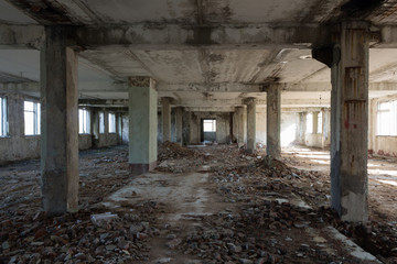 Inside destroyed building, ruins of factory, sunny day, perspective