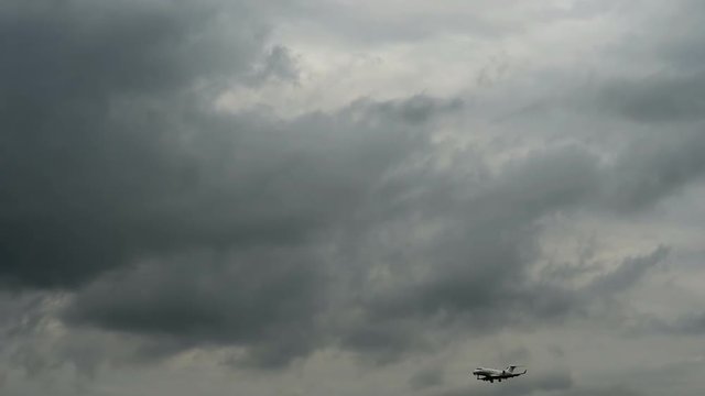 Business jet approaching against stormy cloud