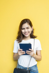 portrait of beautiful university student are smiling on yellow wall background