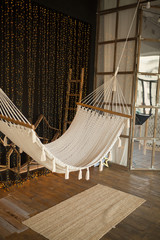 Room interior with hammock and stylish decorations and stairs