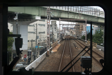  The train ride on the track of the railway corridor in Japan. Railway transport on the Osaka - Kobe route, Keihanshin, Japan.