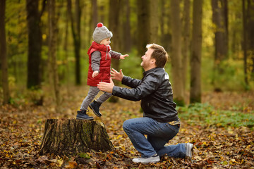 Little boy with his father during stroll in the forest