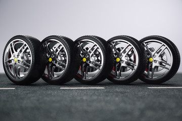 Obraz na płótnie Canvas Car wheel, car tire standing on a road. Concept tyres. Car tire with a disc standing on the asphalt road. 3D illustration