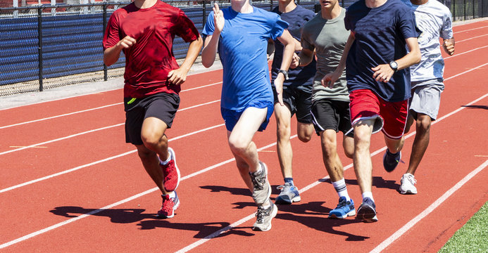 Group of runners training on a track together