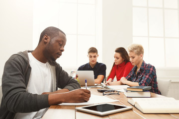 Black man using laptop at modern office