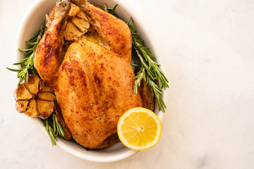 Roast chicken with lemons, garlic and rosemary for Christmas. Christmas concept. Top view.