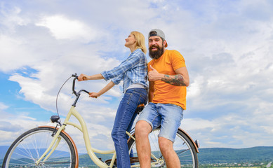 Man and woman spend active leisure with bike. Couple in love date outdoors cycling. Bike rental or bike hire for short periods of time. Date ideas. Couple with bicycle romantic date sky background