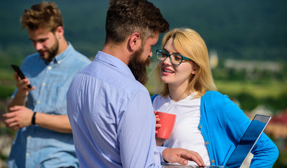 Colleagues with laptop work outdoor sunny day, nature background. Colleagues business partners with...