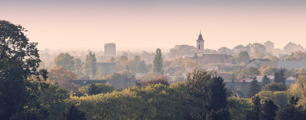Zemun, old city with churches and houses with red roofs,on a foggy, misty morning