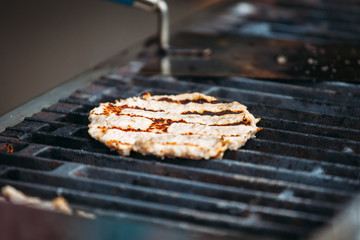 a hamburger cutlet is cooked on the grill