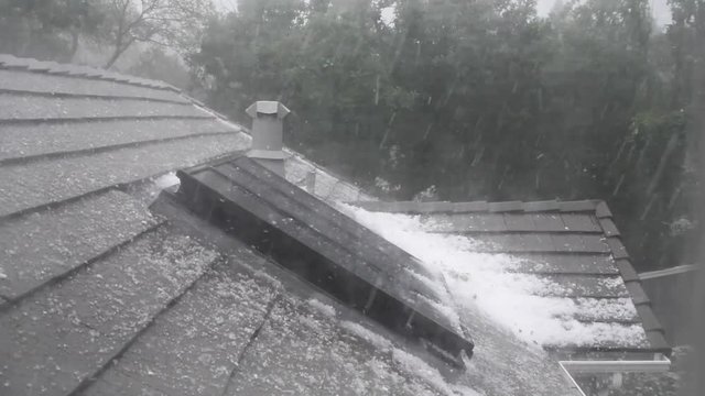 Hail storm on the roof of a house