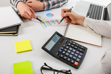 Business concept. Two business mans working and meeting with chart at office on his desk.