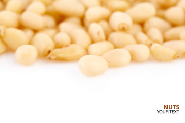 Peeled pine nuts on a white background. Healthy food. Nuts.