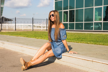 Fototapeta premium Girl sitting on street in summer day