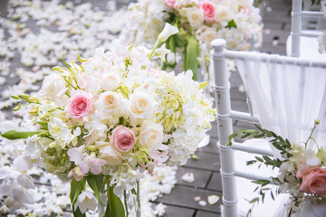 Chair decorated with flowers in Wedding ceremony.