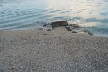Sunlight reflecting on the water of a sandy beach