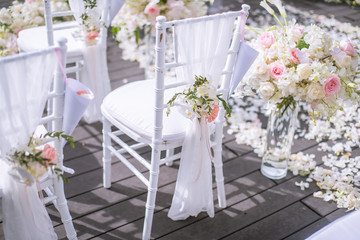 Chair decorated with flowers in Wedding ceremony.