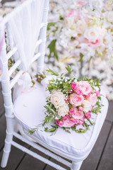 Chair decorated with flowers in Wedding ceremony.