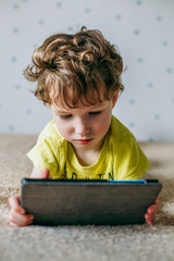 Toddler boy staring at tablet. Education, gadget, dependency, technology, addiction, child...