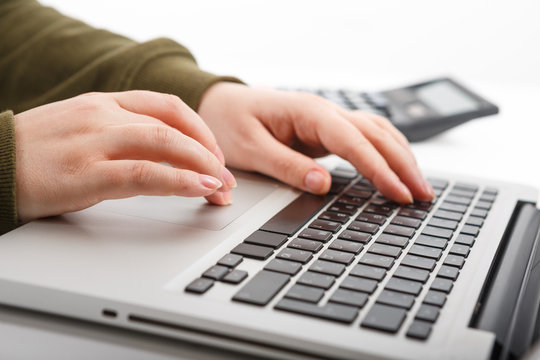 Laptop with woman hand isolated