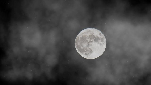 Animation of mystical full moon in the fog on the dark night sky with shining stars.