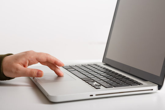 Laptop with woman hand isolated