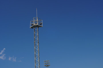 Metal light poles with a blue sky background