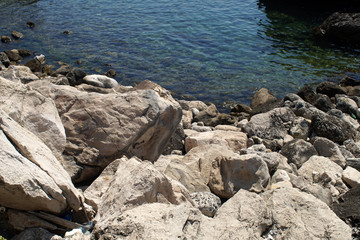 Rocky bay with giant boulders and a clear blue water