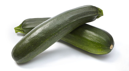 Two fresh zucchini isolated on white background.