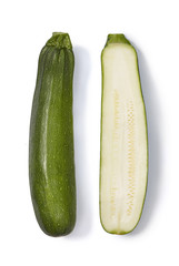 Whole and half of a zucchini isolated on white background. Top view.