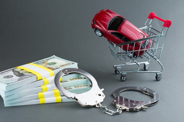  Red car  money handcuffs. shopping for vehicles fraud car sale scam  breaking the law car dealer...