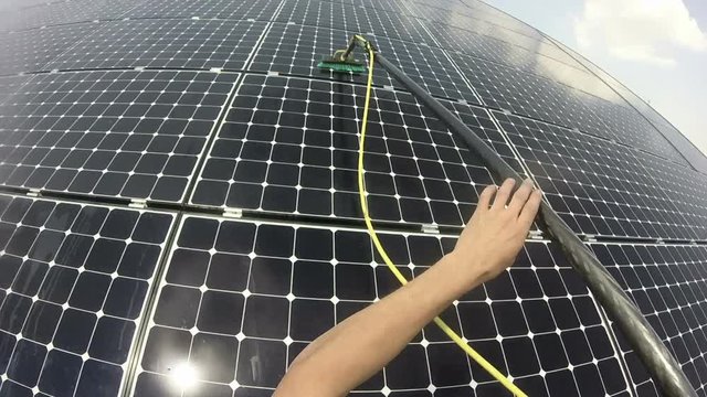 Rope Access Technician Cleaning Photovoltaic Panel Pov
