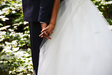 Bride and groom holding hands