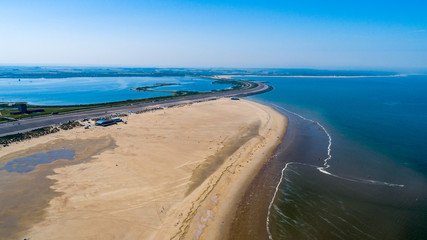 Beach and ocean waves from above taken by a drone in Zeeland in the Netherlands - 217877790