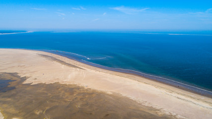 Beach and ocean waves from above taken by a drone in Zeeland in the Netherlands