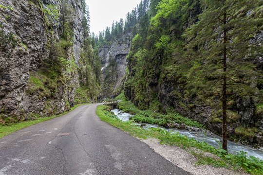 Deep valley incised by a stream, inside which falls a beautiful waterfall, Serrai di Sottoguda, Rocca Pietore, Dolomites, Italy