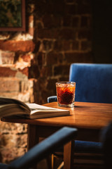Cold brew coffee with ice cubes on the wooden table from above. Urban coffee shop.